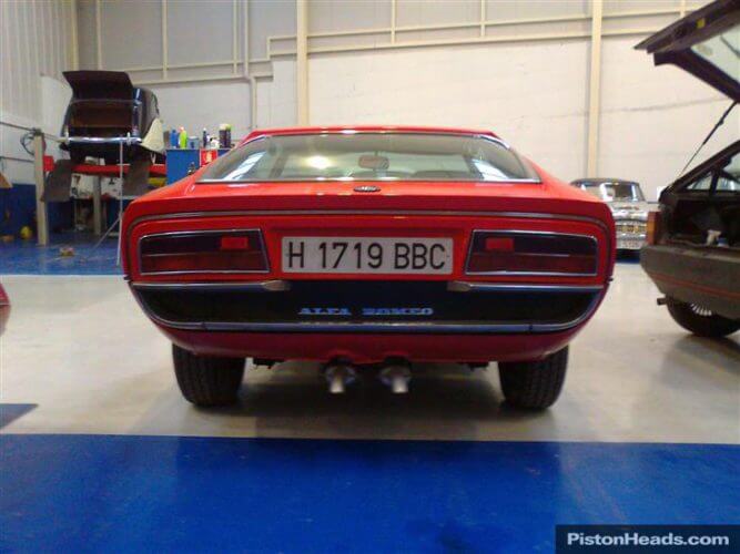 Photo of a Alfa Romeo Montreal from behind.