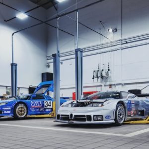 Two Bugatti EB110 race cars arrive at H.R. Owen Bugatti's workshop